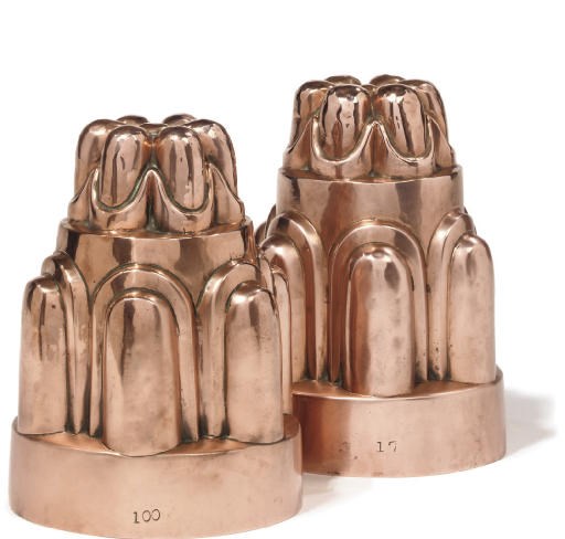 A near pair of Victorian copper castellated jelly moulds