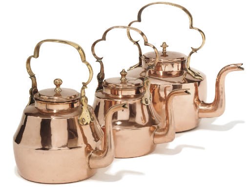 A collection of three English copper kettles