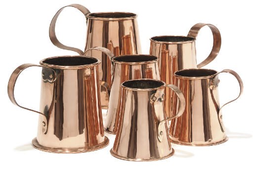 A collection of six English copper ale jugs