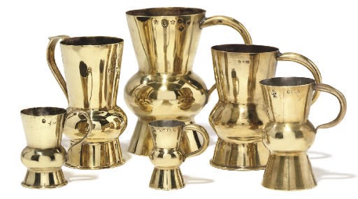 A GROUP OF FOUR SCOTTISH BRASS THISTLE-SHAPED MEASURES