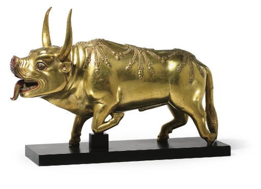 A large gilt bronze figure of a bull mount