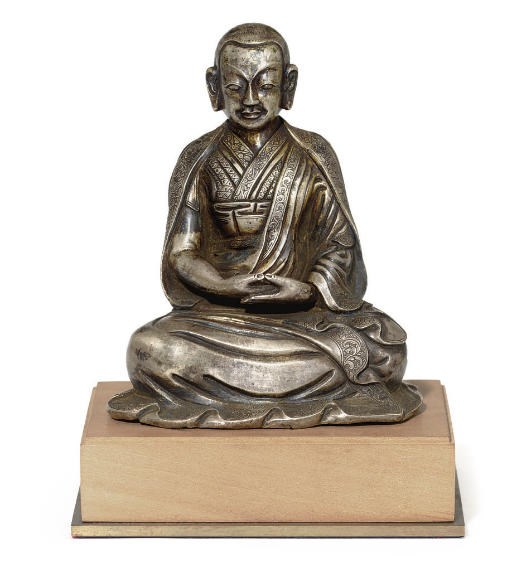 A rare silver figure of a Lama
