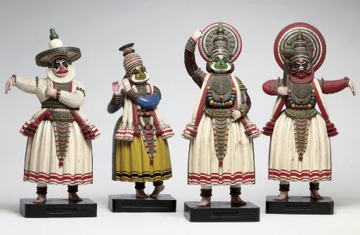 A group of four polychromed wooden figures of characters from Kathakali Dance