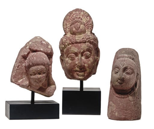 Three small mottled red sandstone figures