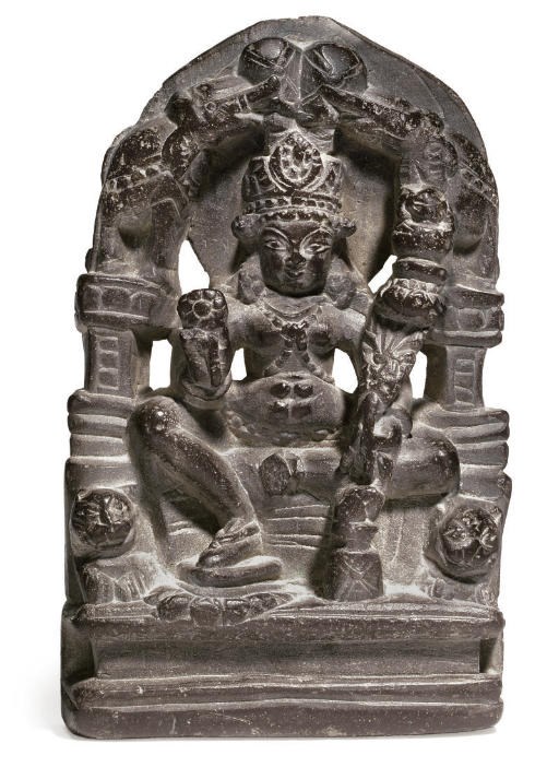 A black stone figure of Gaja Lakshmi