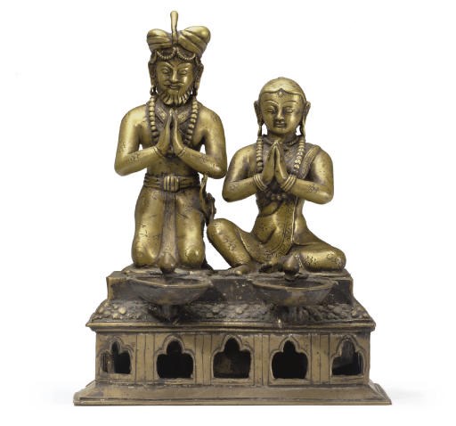 A brass ritual lamp with figures of a King and Queen