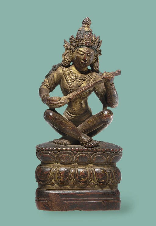A polychromed wooden figure of Saraswati