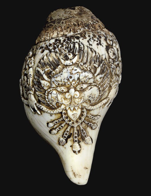 A Conch shell carved with kirttimukha mask