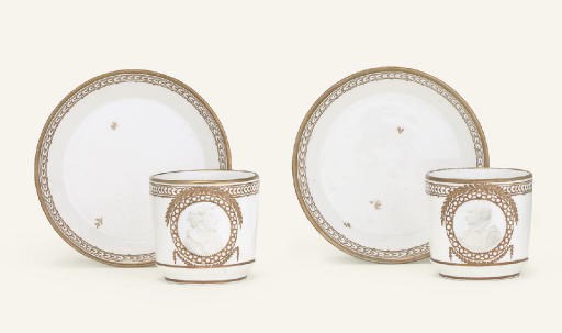 TWO FULDA WHITE AND GILT PORTRAIT COFFEE-CUPS AND SAUCERS