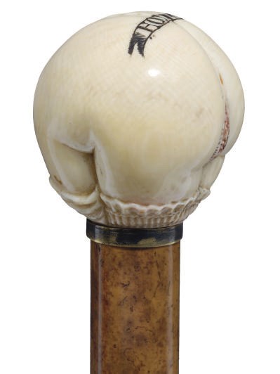AN EROTIC CARVED IVORY AND MALACCA WALKING CANE