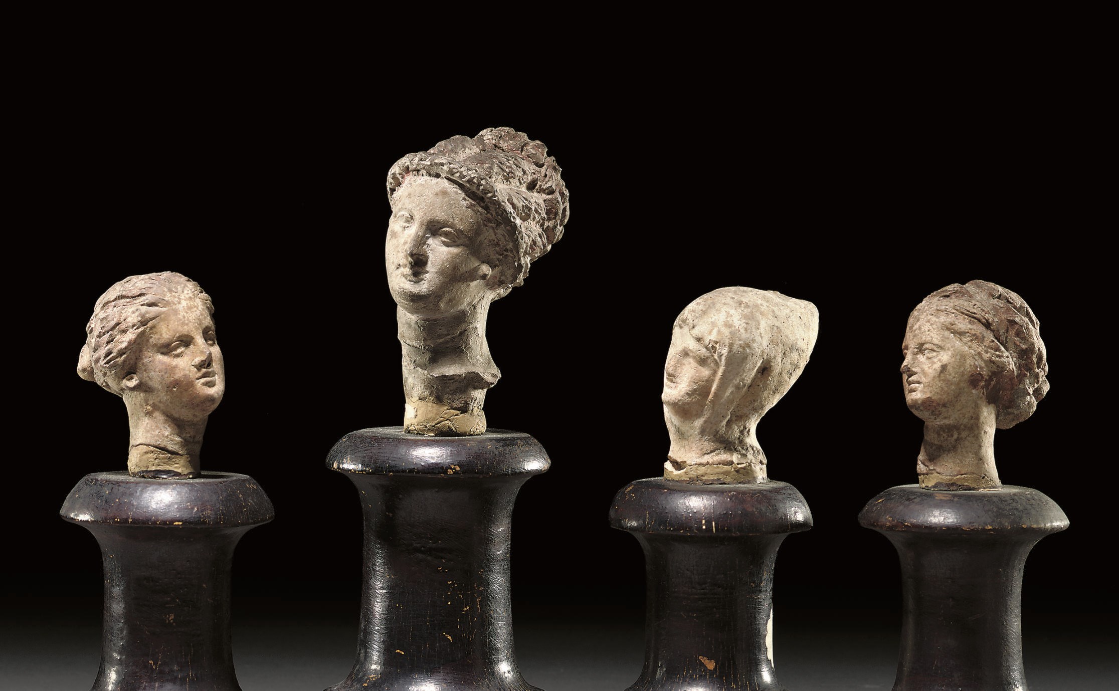 A GROUP OF FIVE GREEK AND SOUTH ITALIAN TERRACOTTA FEMALE HEADS