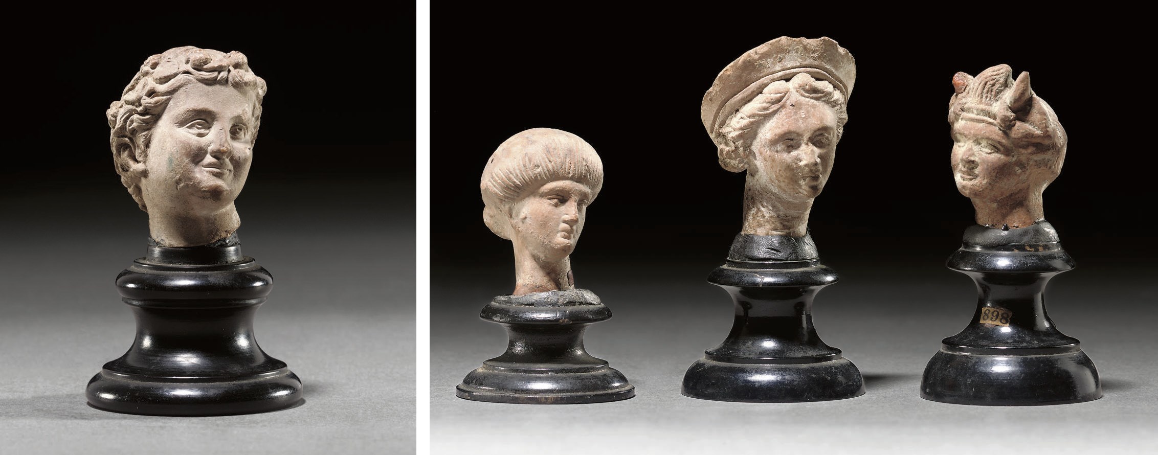 A GREEK TERRACOTTA HEAD OF A WOMAN