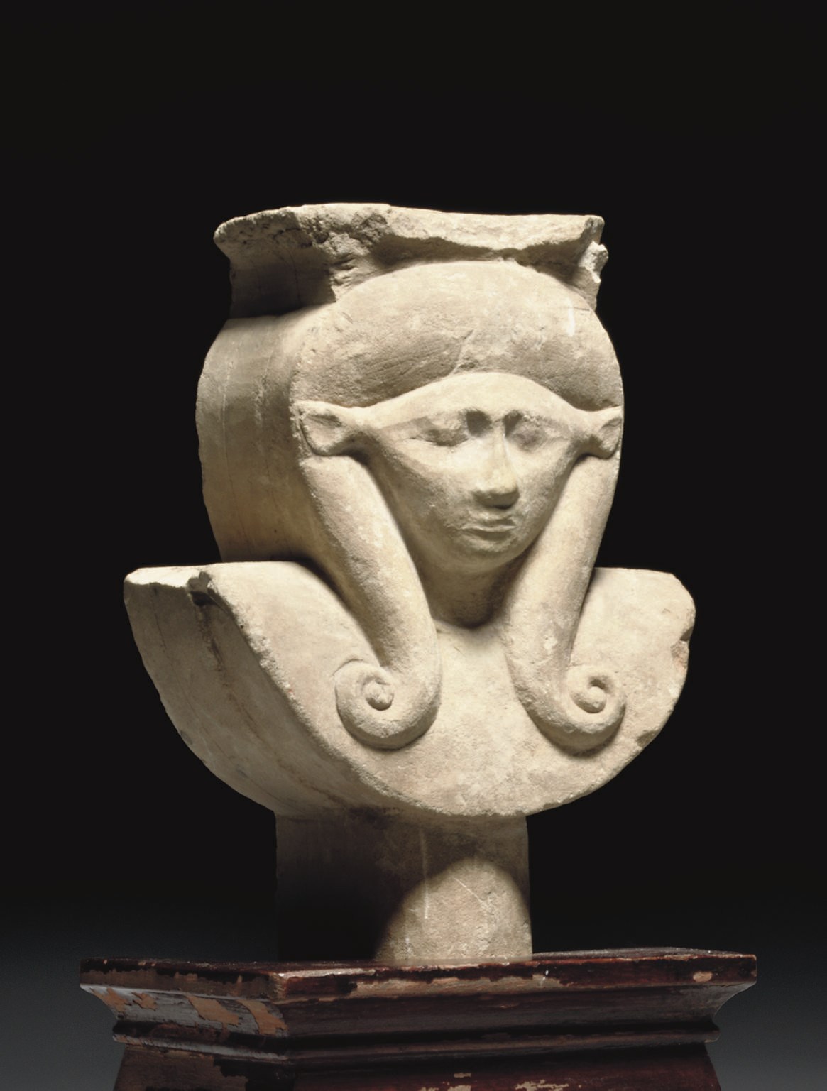AN EGYPTIAN LIMESTONE SCULPTOR'S MODEL OF THE HEAD OF HATHOR