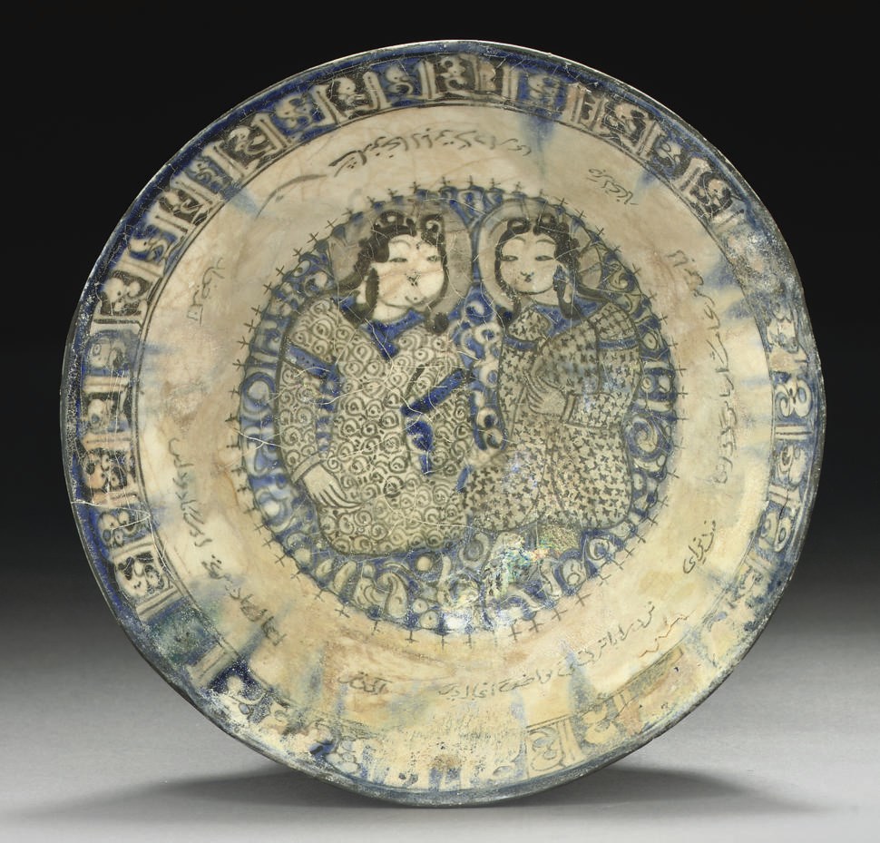 A BLUE AND WHITE BOWL WITH MINAI FACES, KASHAN, IRAN, 12TH CENTURY
