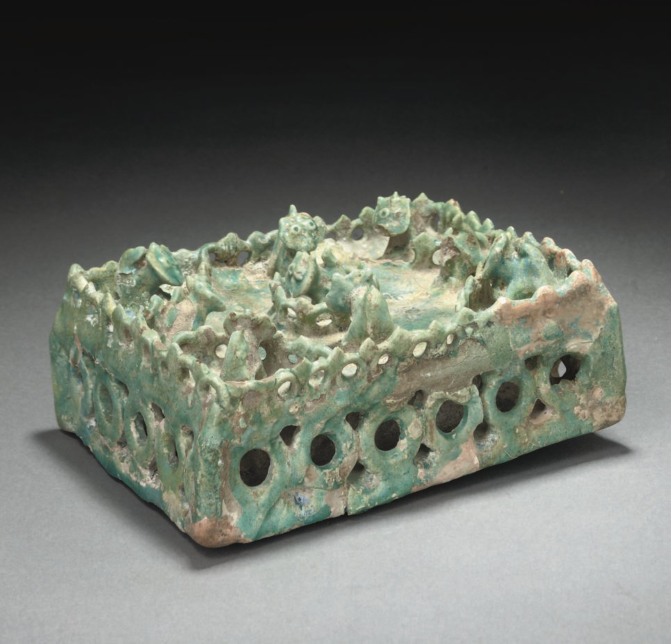 A KASHAN TURQUOISE GLAZED MOULDED HUNTING SCENE, EASTERN IRAN, 13TH CENTURY