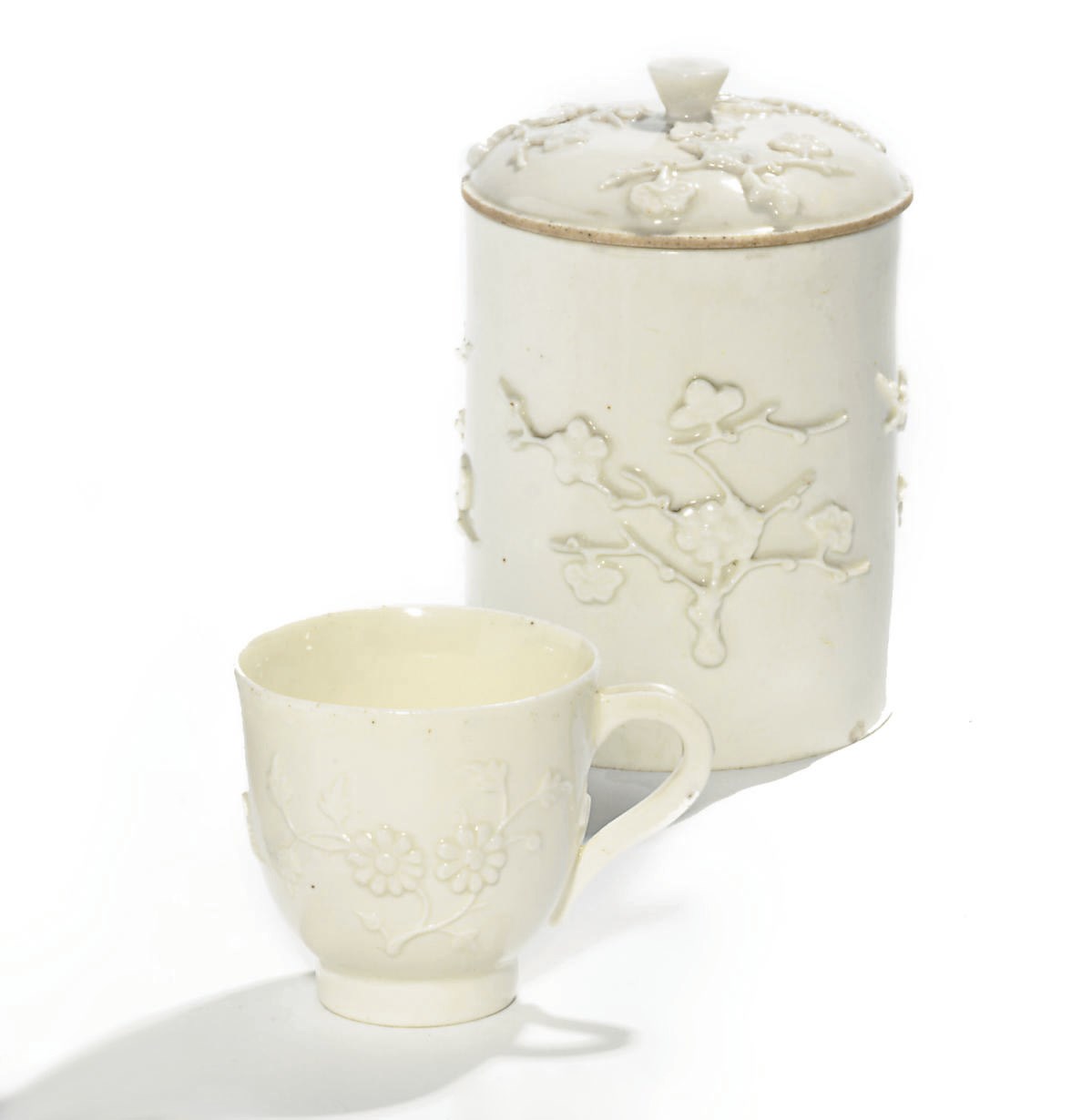A FRENCH SOFTE-PASTE PRUNUS-MOLDED POT A TOILETTE AND COVER