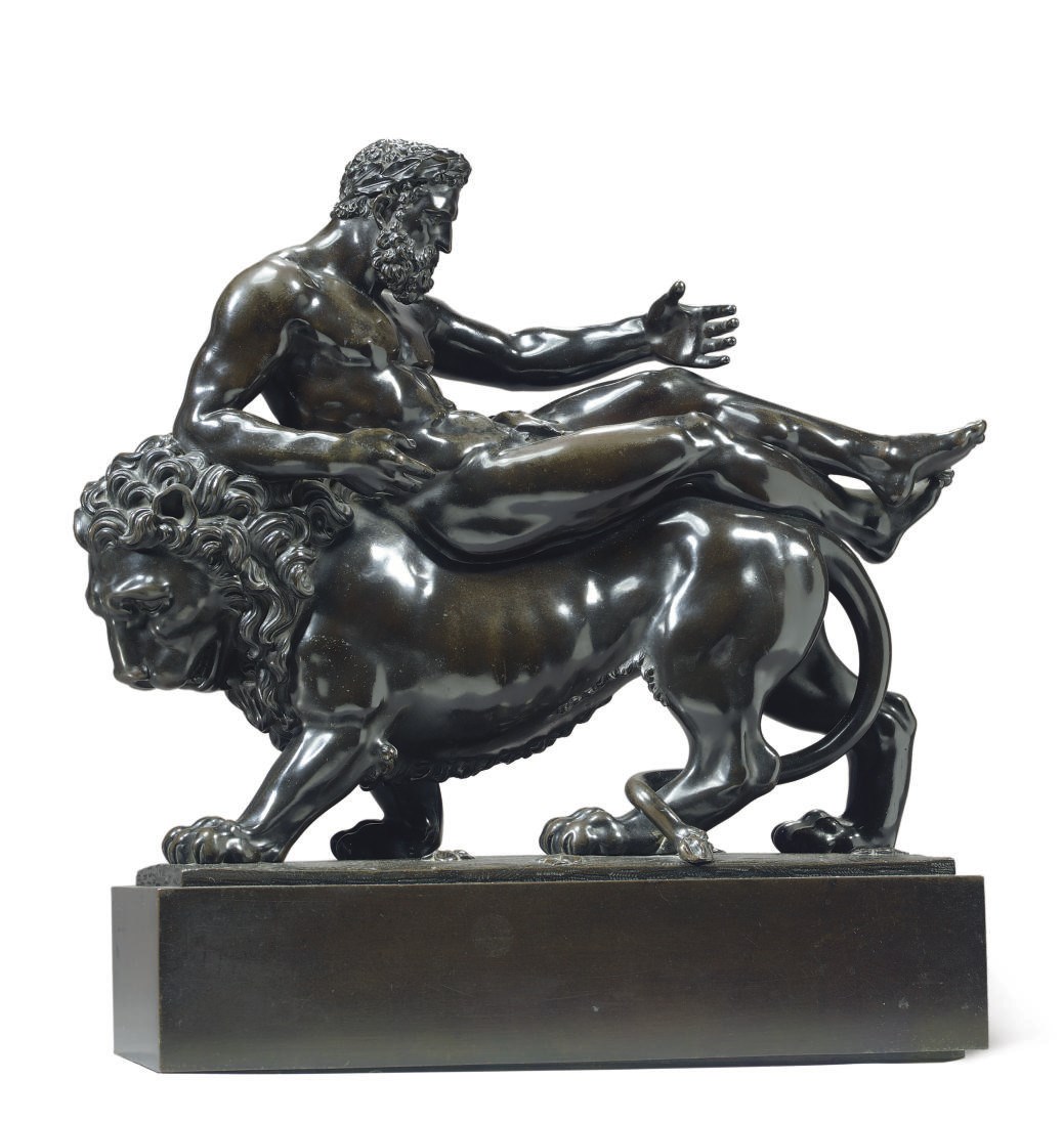 A BRONZE GROUP OF A MAN RIDING A LION