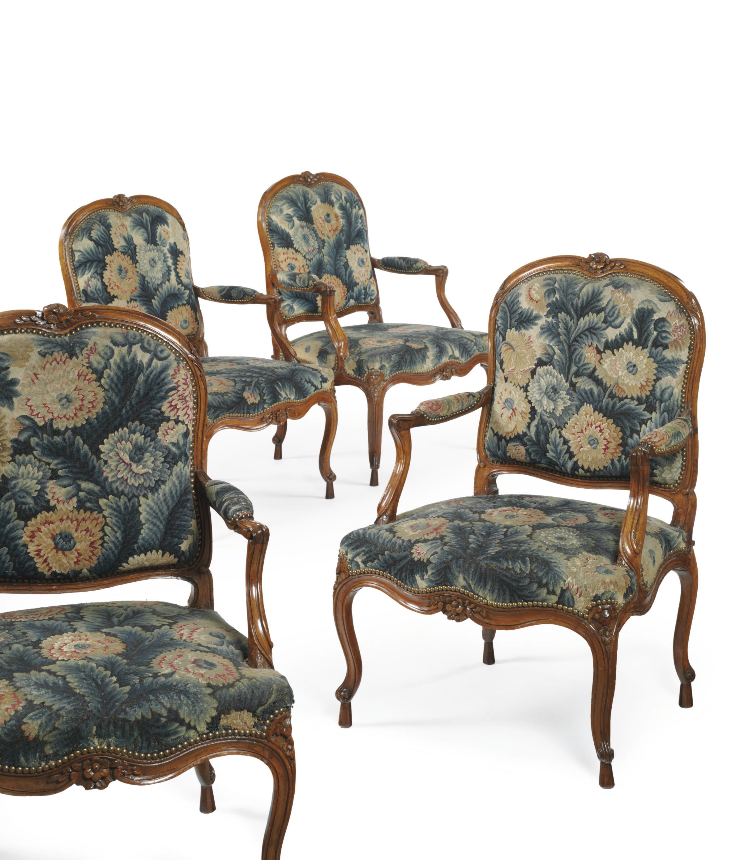 A SET OF FOUR LOUIS XV WALNUT FAUTEUILS