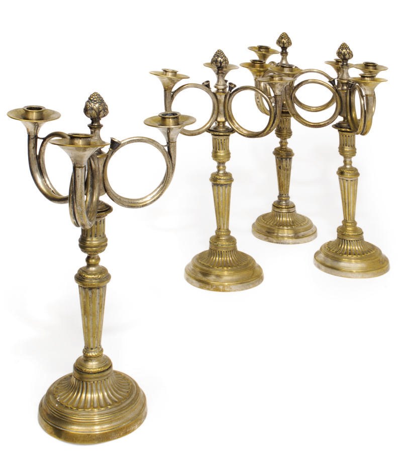 A SET OF FOUR FRENCH SILVER-PLATED BRASS THREE-LIGHT CANDELABRA