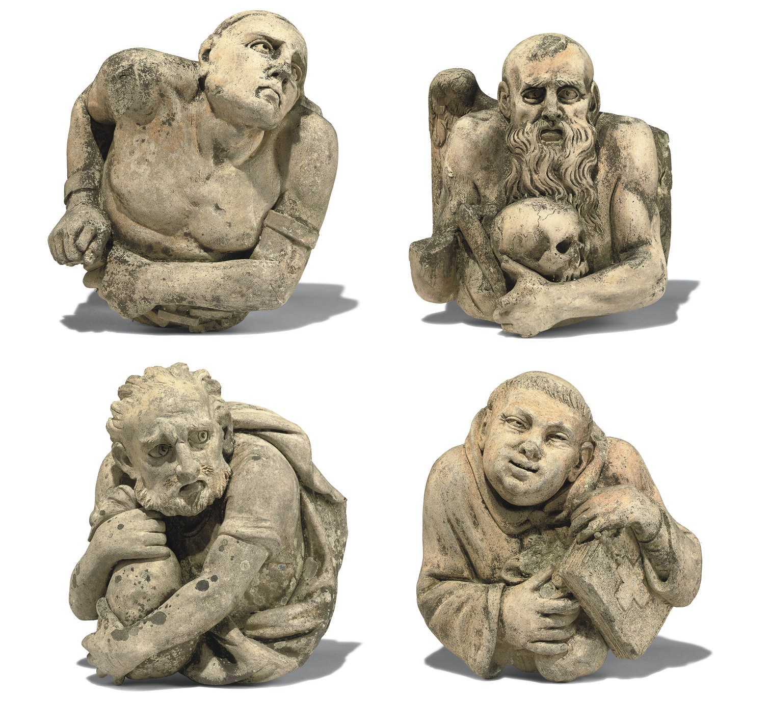 A GROUP OF FOUR ARTIFICAL STONE GOTHIC CORBELS