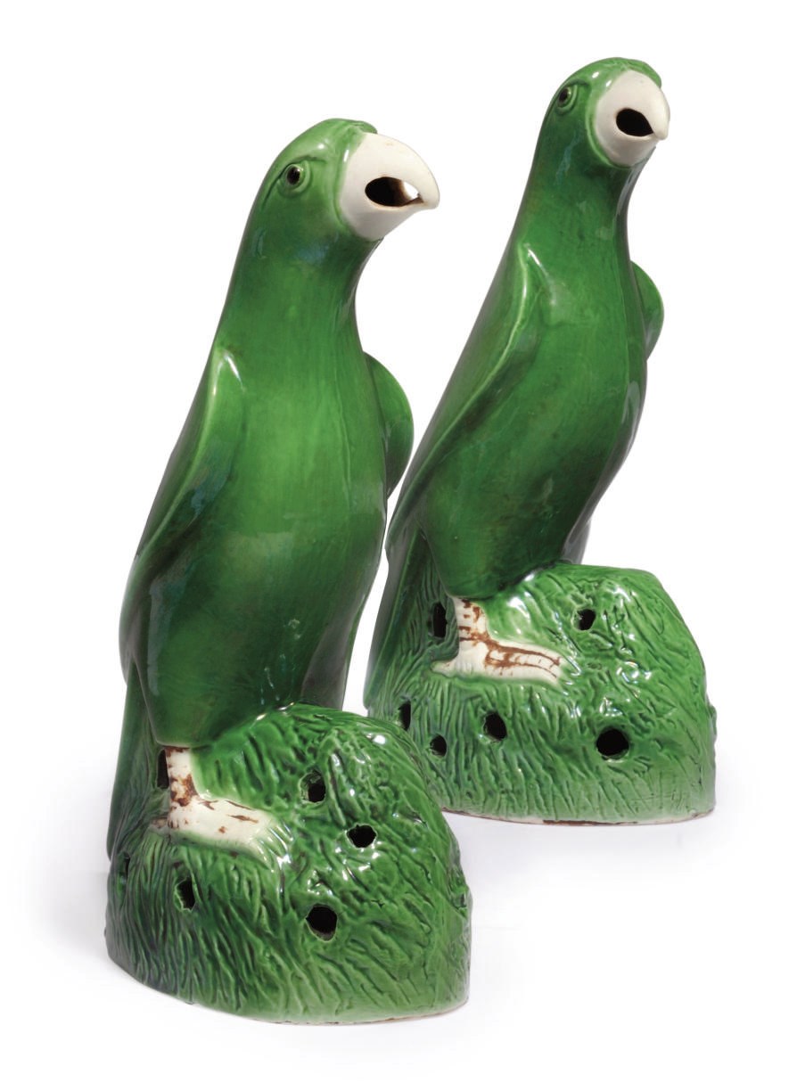 A pair of Chinese green glazed biscuit parrots