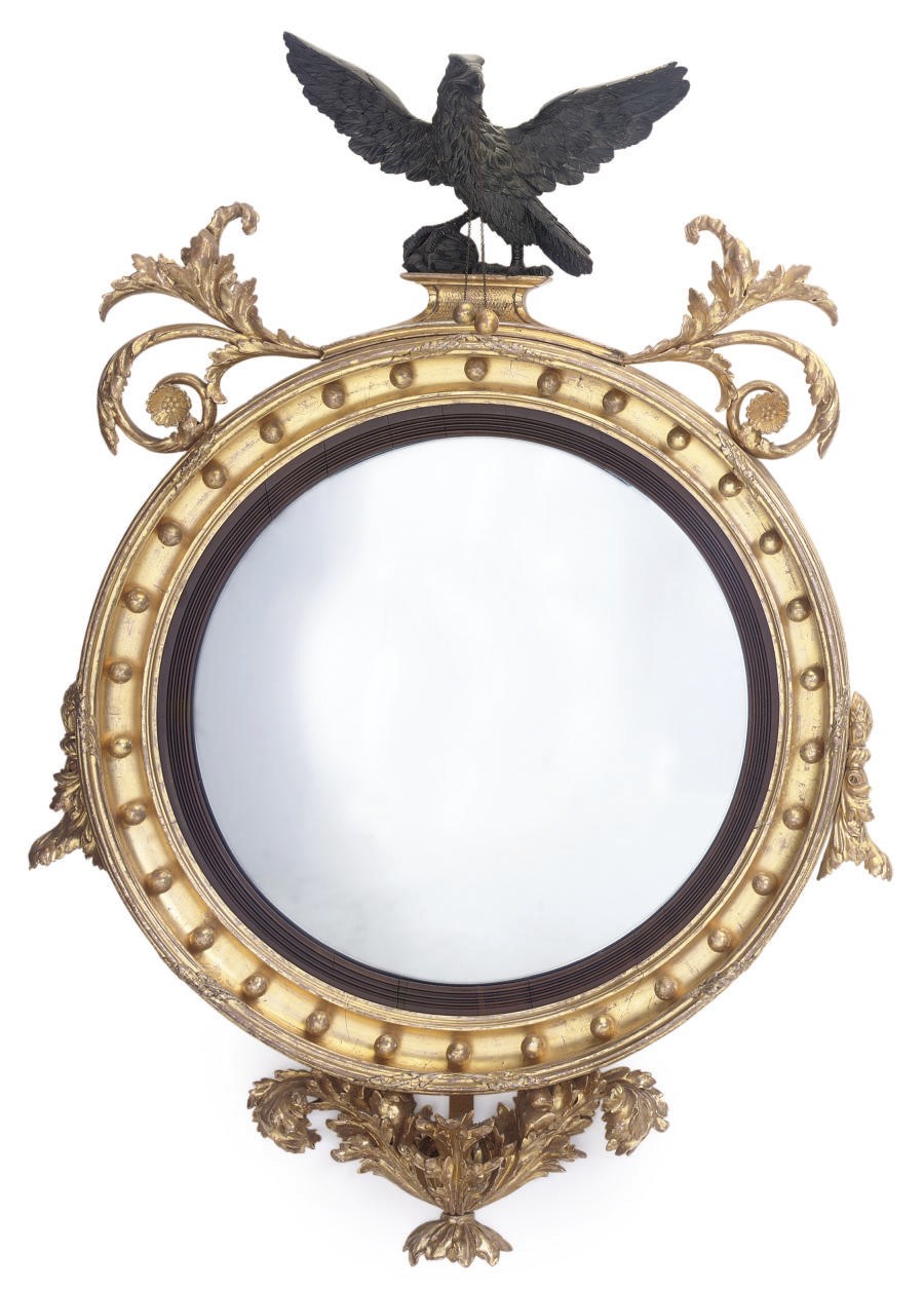 A WILLIAM IV GILTWOOD AND EBONISED CONVEX MIRROR