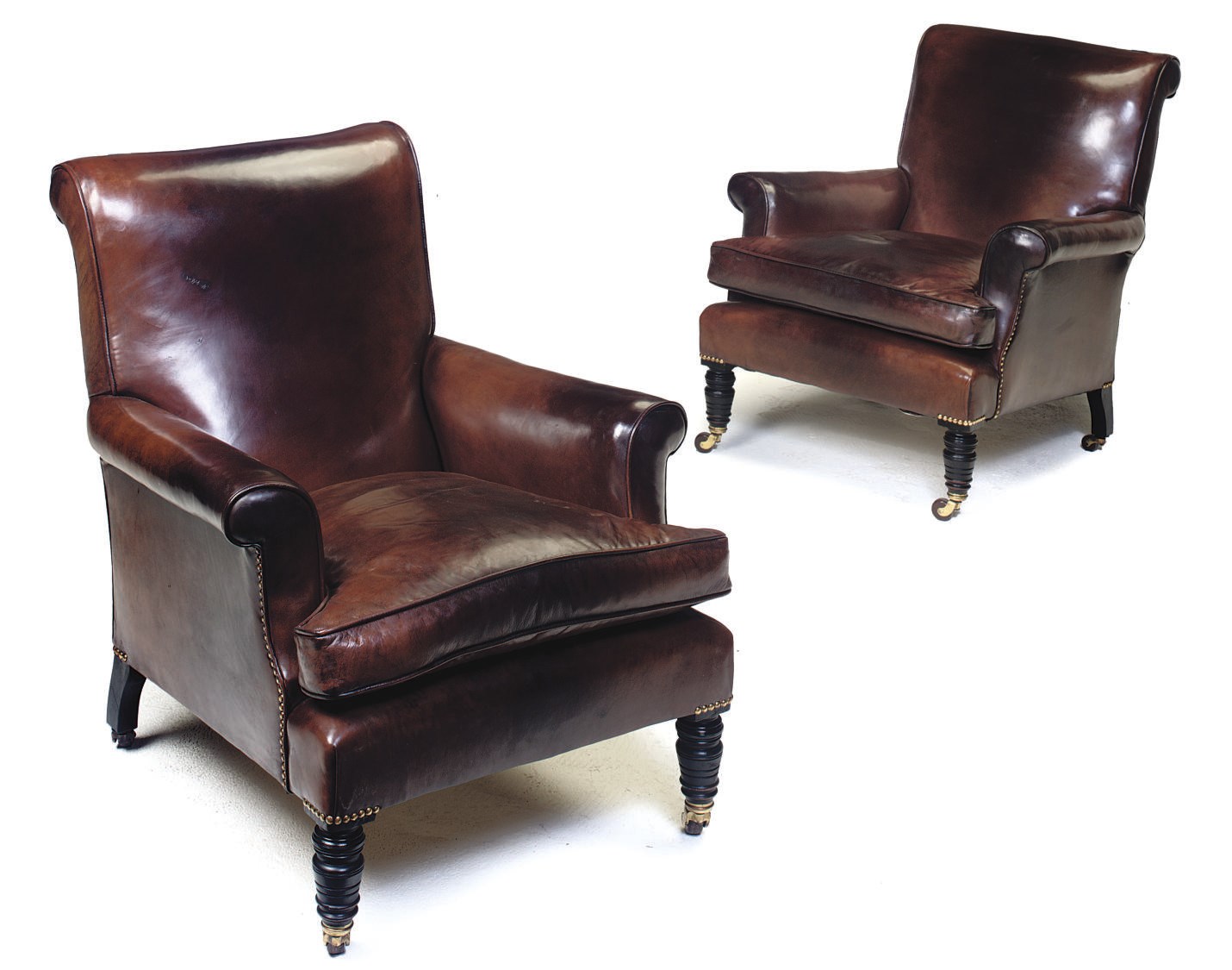 A PAIR OF BROWN LEATHER UPHOLSTERED EASY ARMCHAIRS