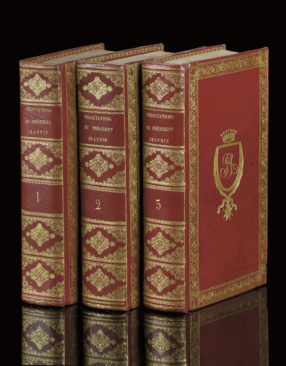 JEANNIN, Pierre (1540-c.1622). Négociations diplomatiques et politiques. Paris: Petit & Boucher, 1819. 3 volumes, 8° (202 x 122mm). Engraved portrait, half-titles (some foxing). Contemporary French red straight-grained morocco, gilt decorative border round sides enclosing in volumes I and III, a shield containing the monogram F.R.B.P. [? Bourbon Penthièvre], surmounted by a crown and with the order of the Saint Esprit, and in volume II the arms of the duc and duchesse d'Orléans [these arms not in Olivier], inner dentelles, gilt edges. Provenance: The duc et duchesse d'Orléans (gilt supralibros).	 (3)