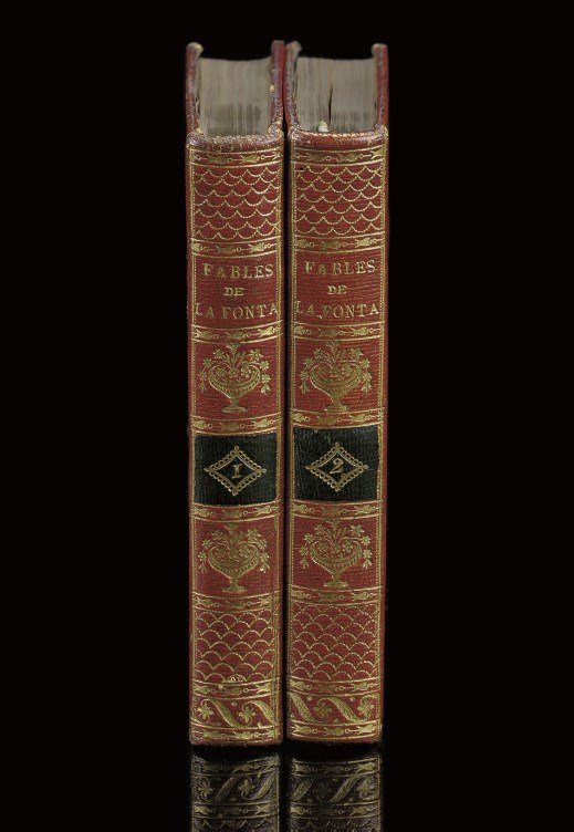 LA FONTAINE, Jean de (1621-1695). Fables. Paris: A.A. Renouard, 1811. 2 volumes, 12° (152 x 95mm). 266 woodcut illustrations, 12 after Moreau le jeune (a little discolouration and offsetting). Contemporary French straight-grained morocco, narrow gilt dentelle and wave border round sides, flat spines gilt, dark green morocco numbering pieces. Provenance: Clle Pauffin (bookplate). Cohen-de Ricci 555.	 (2)