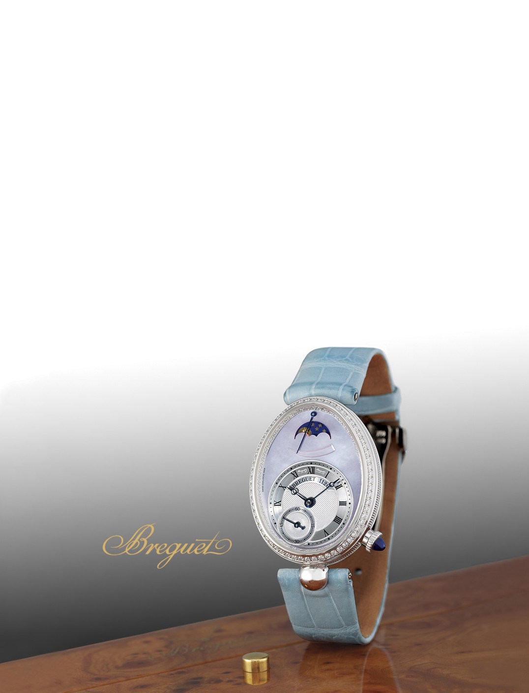 BREGUET, "REINE DE NAPLES"

LADY'S 18K WHITE GOLD AND DIAMOND-SET SELF-WINDING OVOID WRISTWATCH WITH SMALL SECONDS, MOON-PHASES, POWER-RESERVE INDICATION AND MOTHER-OF-PEARL DIAL