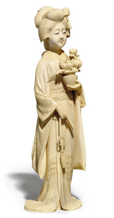 A Japanese ivory okimono of a Young Maiden