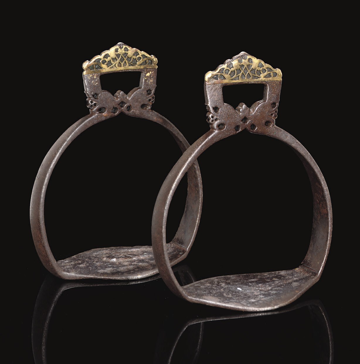 A RARE PAIR OF SAFAVID GILDED IRON STIRRUPS, IRAN, 17TH CENTURY