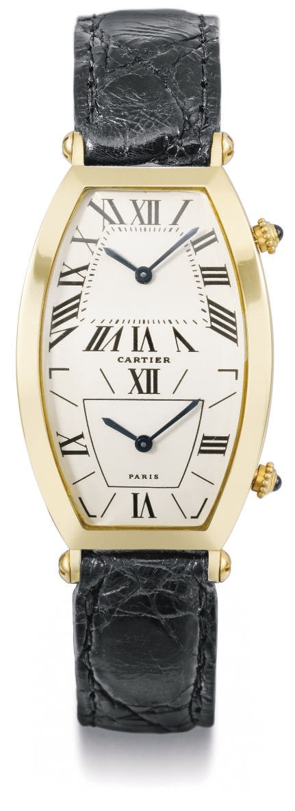 Cartier. A fine 18K gold tonneau-shaped dual time curved wristwatch