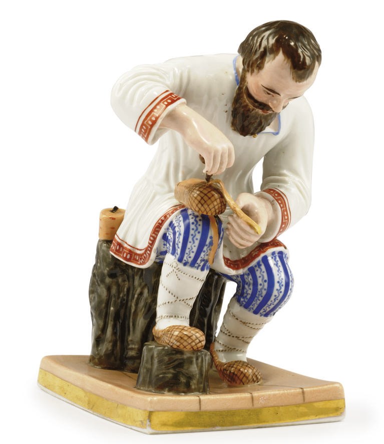 A PORCELAIN FIGURE OF A COBBLER