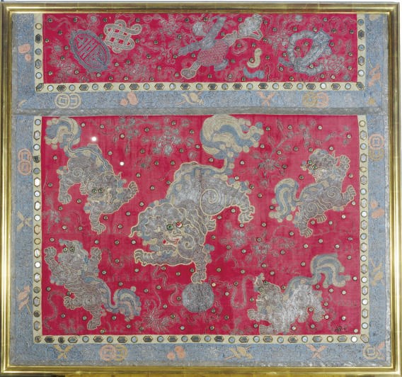 A RED SILK PANEL FRAGMENT EMBROIDERED WITH LIONS,