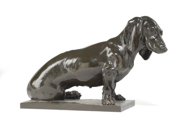 A GERMAN PATINATED METAL FIGURE OF A DOG,