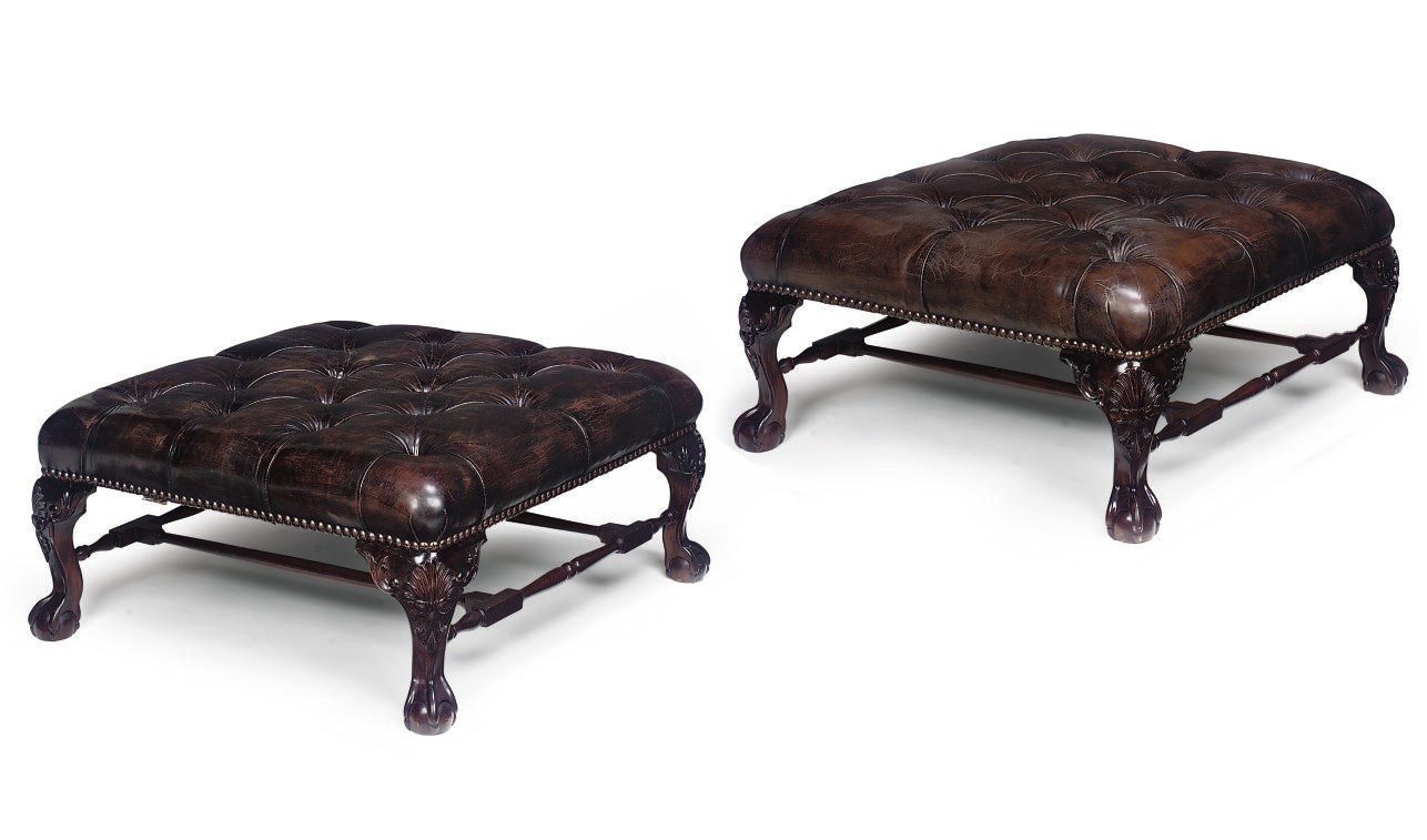 A PAIR OF LARGE BROWN LEATHER UPHOLSTERED AND MAHOGANY STOOLS