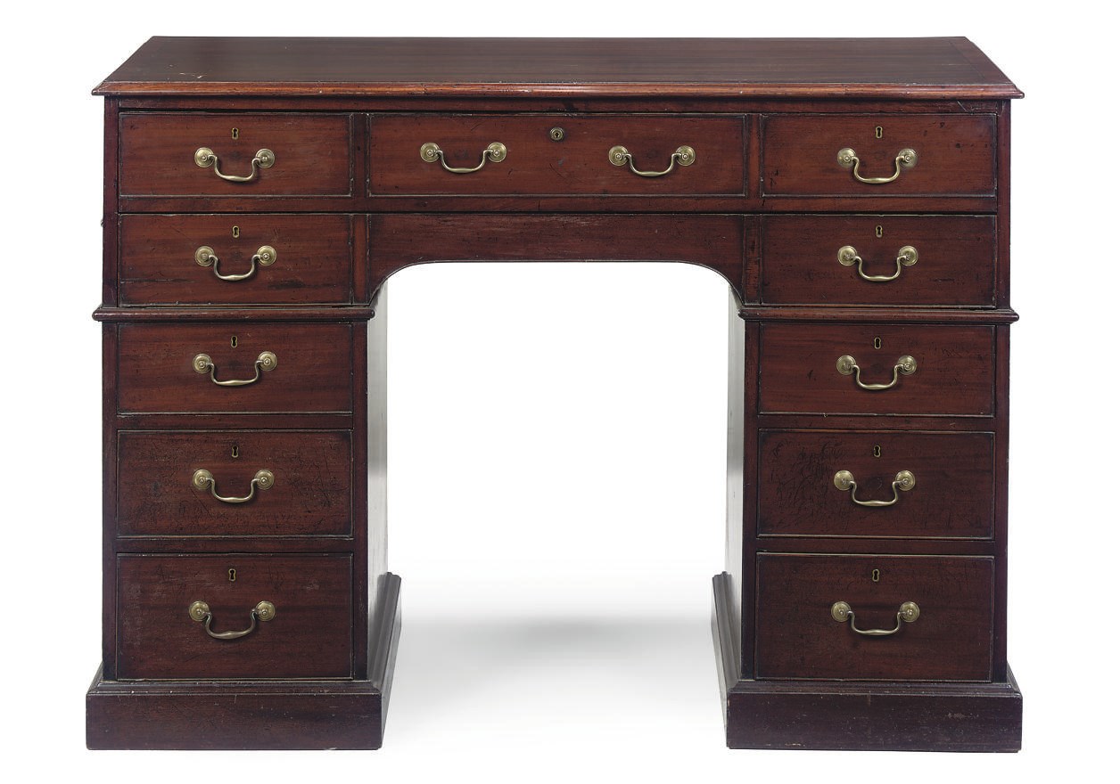 A LATE GEORGE III MAHOGANY KNEEHOLE WRITING TABLE