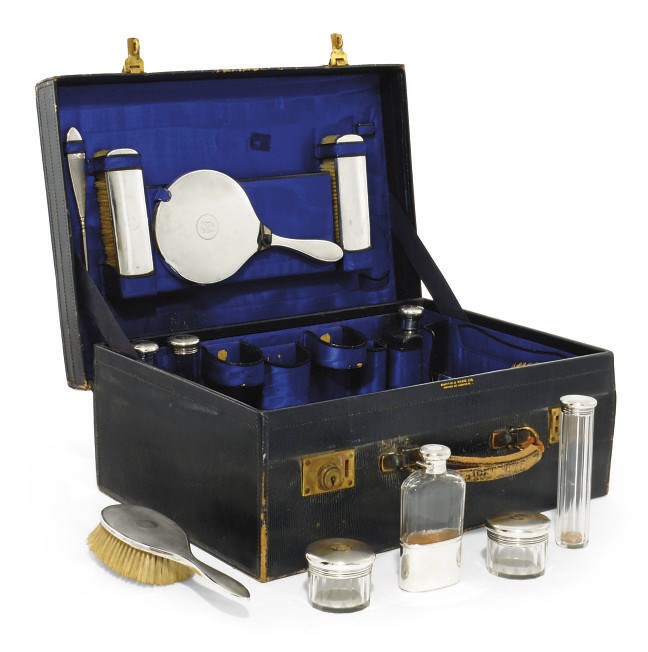 A SILVER-MOUNTED GLASS GENTLEMAN'S TRAVELLING DRESSING TABLE SET