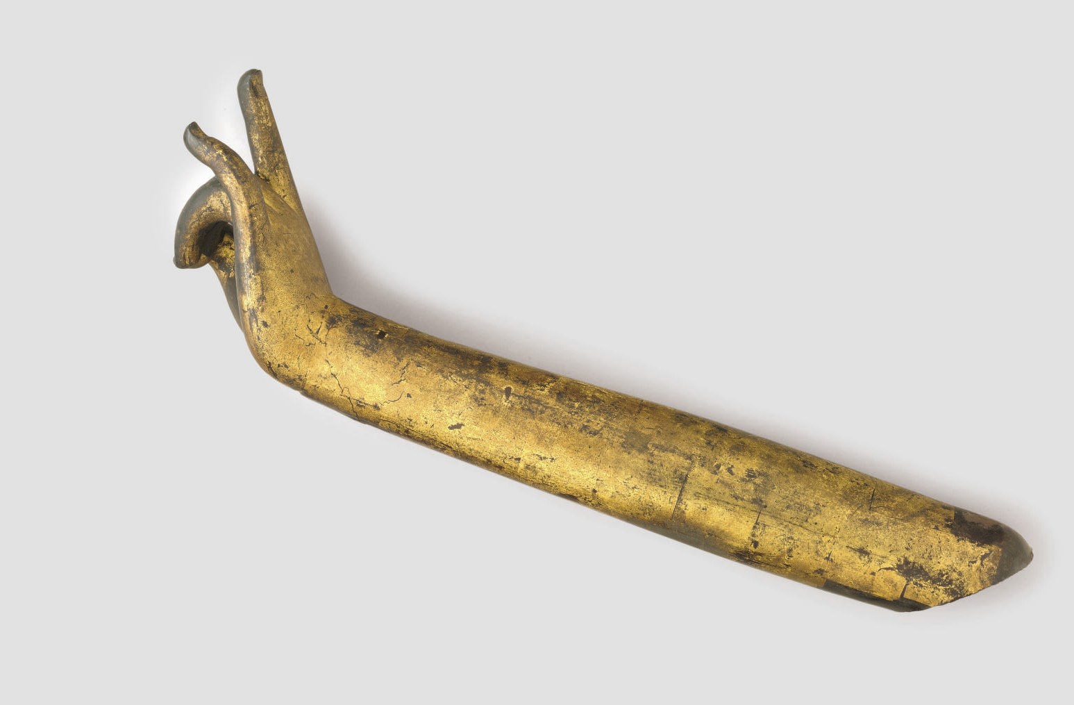 A gilt and lacquered wood arm and hand from a Buddhist sculpture