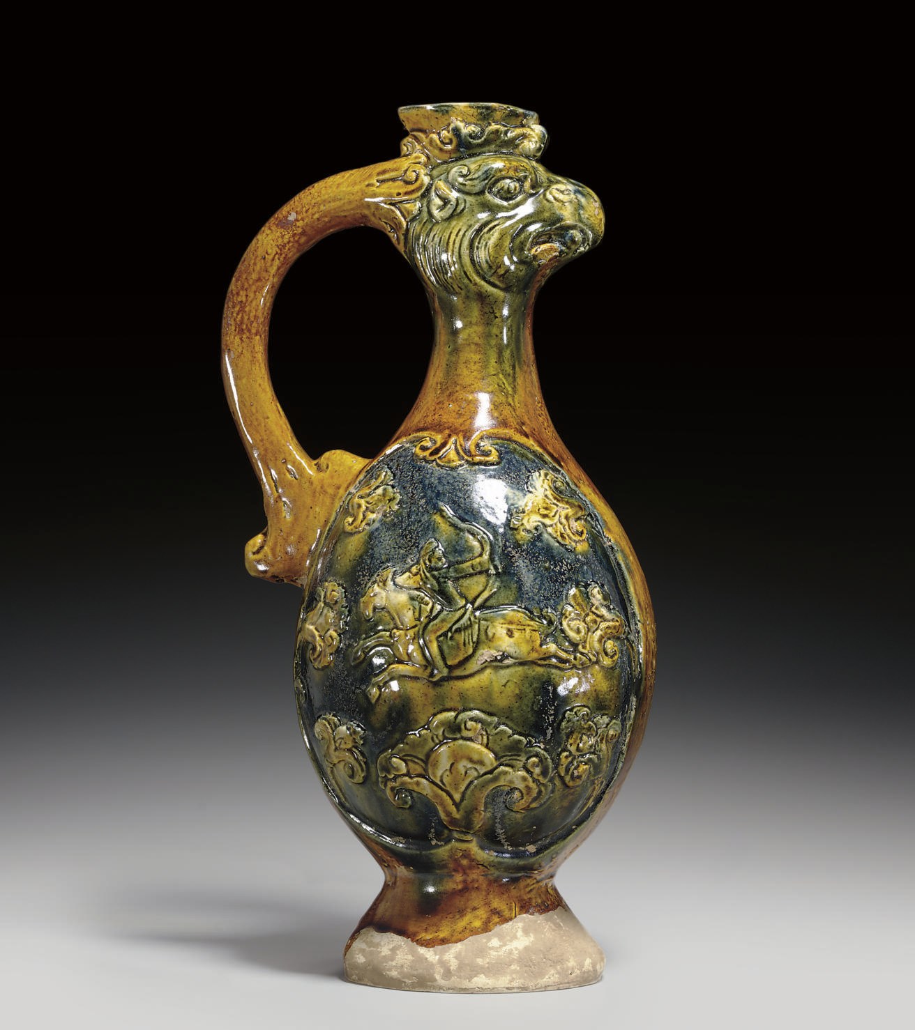 A BLUE, AMBER AND CREAM-GLAZED POTTERY 'PHOENIX' EWER