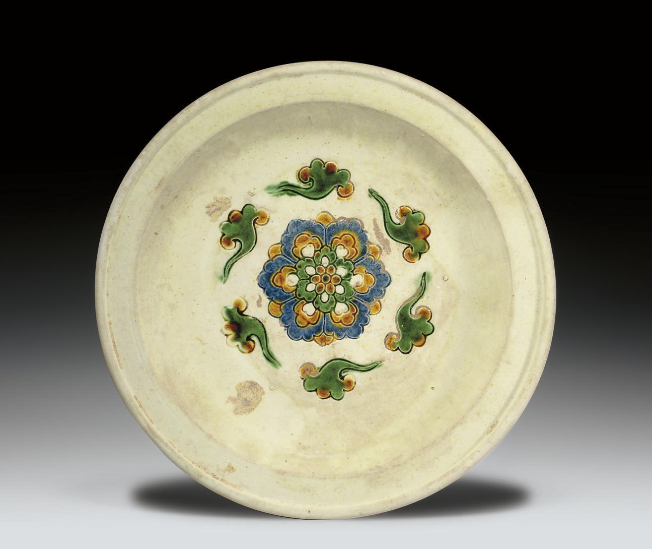 A BLUE, AMBER AND CREAM-GLAZED TRIPOD DISH