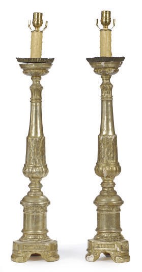 A PAIR OF PARCEL-GILT COMPOSITION PRICKET STICKS MOUNTED AS TABLE LAMPS,