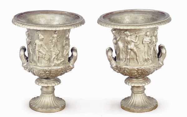 A PAIR OF SILVER-PAINTED CAST-IRON RELIEF MOLDED URNS,