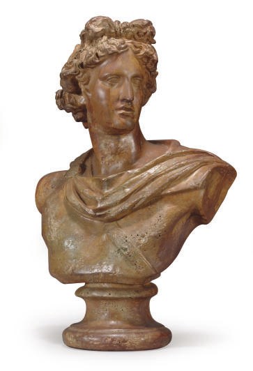 A PAINTED TERRACOTTA BUST OF APOLLO