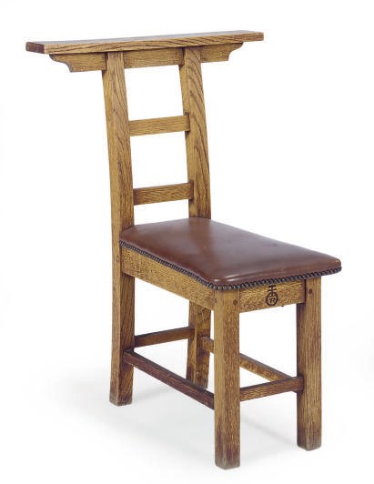 AN OAK AND LEATHER STRADDLE CHAIR,