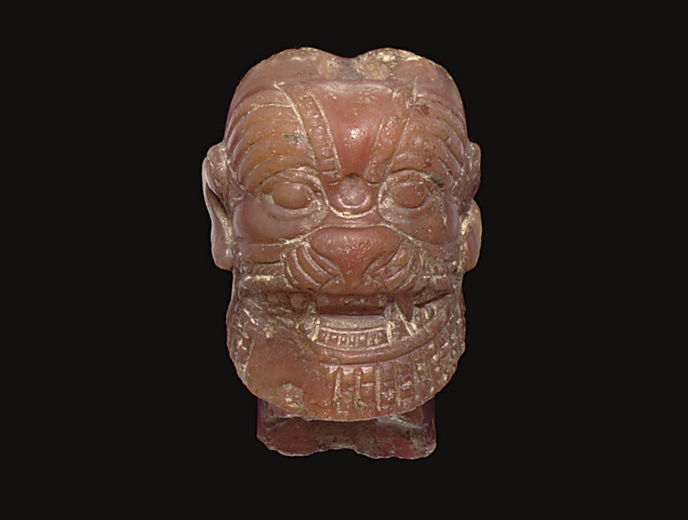 A NEO-ASSYRIAN CARNELIAN HEAD OF PAZUZU
