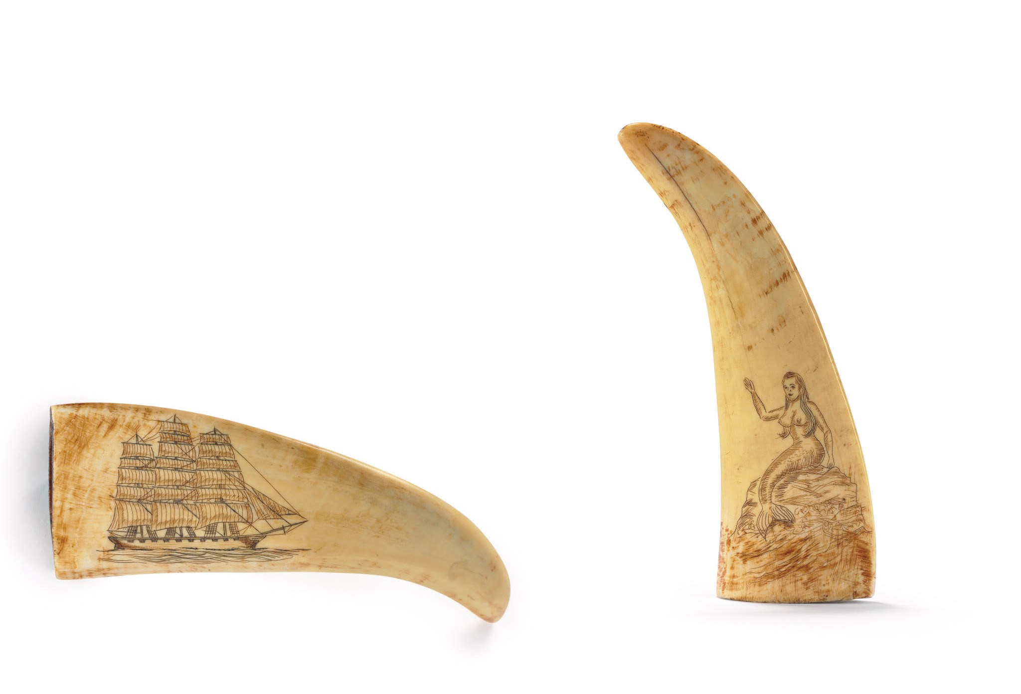 A SCRIMSHAW WHALE TOOTH