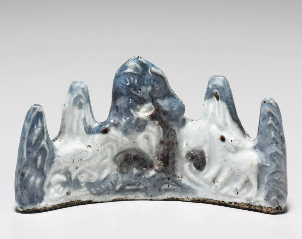 A Copper-Red and Blue and white Porcelain Brush Rest in the form of Mount Geumgang