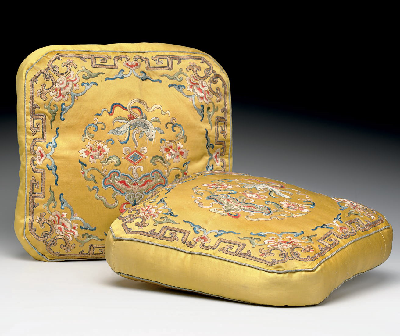 A RARE PAIR OF EMBROIDERED YELLOW SILK SQUARE CUSHIONS